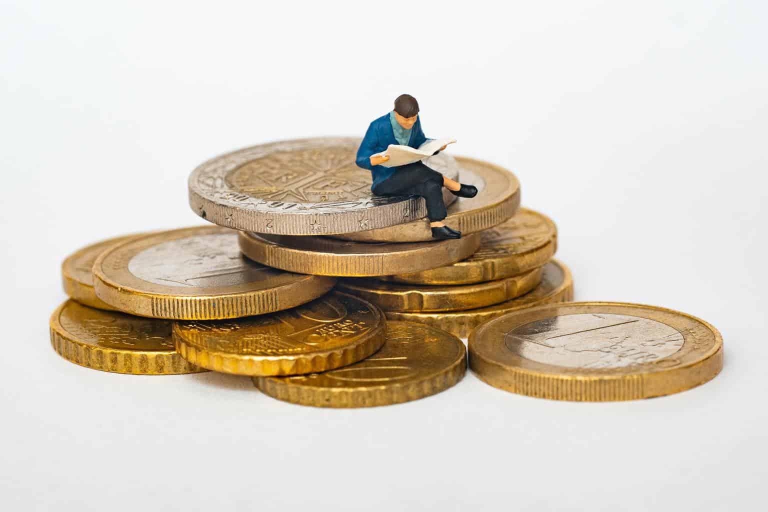 Figurine sitting on coins